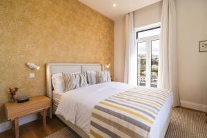 a bedroom with a large bed and a window at Solar do Ilheuzinho in Câmara de Lobos +34 photos