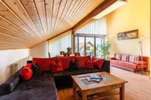 a living room with a couch and a table at Marlene in Friesenheim