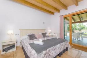 a bedroom with a large bed and a large window at Sa Sargantana in Islas Baleares +28 photos