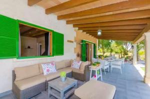 a patio with a couch and a table at Sa Sargantana in Islas Baleares