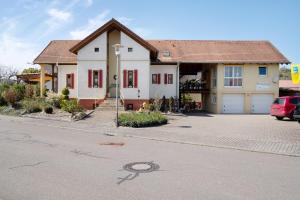 a house on a street with a driveway at Ferienwohnung Lang, 45qm in Sasbach am Kaiserstuhl