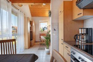 a small kitchen with a table and a window at Ferienwohnung Lang, 45qm in Sasbach am Kaiserstuhl
