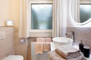 a bathroom with a sink and a toilet and a window at Ferienwohnung Bergwiese in Schmallenberg