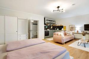 a bedroom with a large bed and a living room at Ferienwohnung Bergwiese in Schmallenberg +13 photos