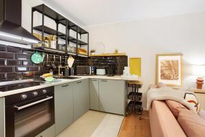 a kitchen with a stove top oven next to a couch at Ferienwohnung Bergwiese in Schmallenberg