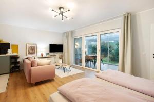 a bedroom with a bed and a chair and a television at Ferienwohnung Bergwiese in Schmallenberg