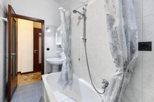 a bathroom with a bath tub and a sink at Casa Grace - Casa al Mare in Vado Ligure +21 photos