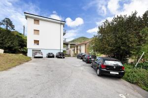 a group of cars parked on the side of a street at Casa Grace - Casa al Mare in Vado Ligure