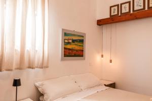 a bedroom with a bed and a painting on the wall at Cantina Rustica in Montallegro
