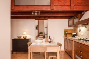 a kitchen with a table with a bottle of wine at Cantina Rustica in Montallegro