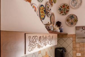 a kitchen with plates on the wall and a hood at Cantina Rustica in Montallegro