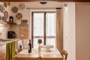 a kitchen with a table and a window at Cantina Rustica in Montallegro +13 photos