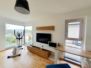 a living room with a desk and a tv and a table at Luxury Villa Vienna in Mauerbach