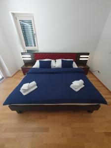 a bedroom with a large blue bed with two white towels at Luxury Villa Vienna in Mauerbach +19 photos