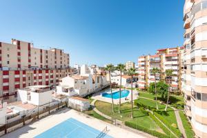 an apartment with a swimming pool and some buildings at Plazamar 044 in Torre del Mar