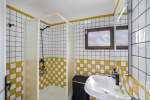 a yellow and white bathroom with a sink and a shower at Hacienda Los Adejo in Moya +37 photos