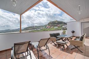 a room with a table and chairs and a view at Hacienda Los Adejo in Moya