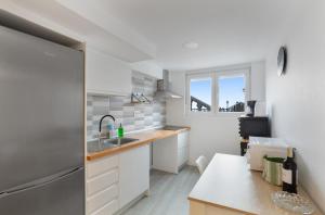 a kitchen with white cabinets and a sink at Hacienda Los Adejo in Moya