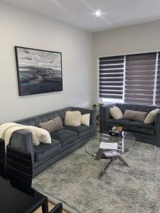 a living room with a couch and a table at The Millertime Experience in Brantford
