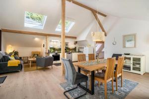 a dining room and living room with a table and chairs at Haus Wiesenruhe in Seebach