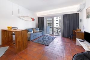 a living room with a couch and a table at Estoril Art and Surf in Estoril
