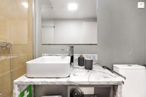 a bathroom with a sink and a white counter top at Estoril Art and Surf in Estoril +8 photos