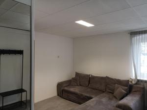 a living room with a couch and a window at Ferienwohnung In Krumbach in Krumbach +2 photos