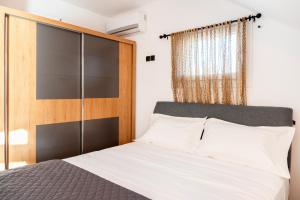 a bedroom with a bed and a wooden headboard at Mont' Rock villas 3 in Posidhonía +18 photos