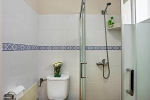 a bathroom with a toilet with a glass shower stall at Formosa Beach in Porto Santo +15 photos