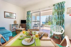 a living room with a table with food on it at Formosa Beach in Porto Santo