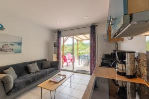 a living room with a couch and a table at Le Pequelet in Payzac