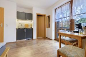 a kitchen with a desk and a table in a room at Ferienidyll Zwiesel in Zwiesel