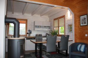 a kitchen with a dining table and a stove at Ferienhaus Zuehlke in Groß Nemerow +13 photos