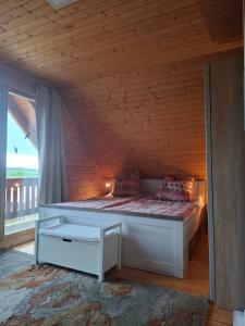 a bed in a room with a wooden ceiling at Ferienhaus Zuehlke in Groß Nemerow