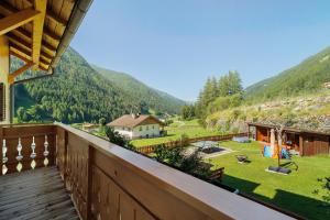 a balcony of a house with a view of a yard at Pension Waldheim Apartments in San Giacomo