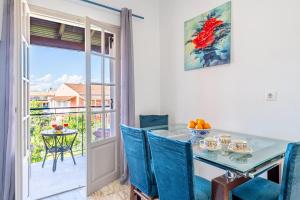 a dining room with a table and chairs and a window at Kassiopi Apartment 2 in Kassiopi