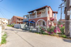 a house with a fence in front of it at Kassiopi Apartment 2 in Kassiopi