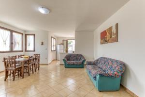 a living room with a couch and a table and chairs at Villa Liscedde Leuca in Castrignano del Capo