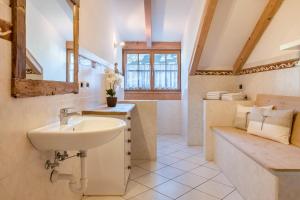 a bathroom with a sink and a mirror at Lotschenhof Apt Tulpe in Trodena +16 photos