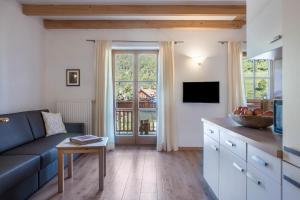 a living room with a blue couch and a table at Lotschenhof Apt Tulpe in Trodena