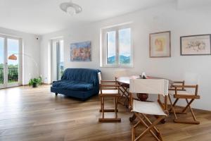 a living room with a blue couch and a table at Villa Angelina in Lavagna