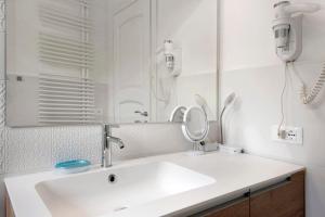 a bathroom with a white sink and a mirror at Villa Angelina in Lavagna +17 photos