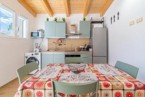 a kitchen and dining room with a table and chairs at Baglio Netino in Noto