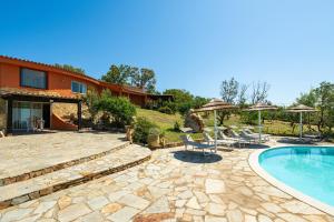 a villa with a swimming pool and a house at Harmònia Residence in Villasimius