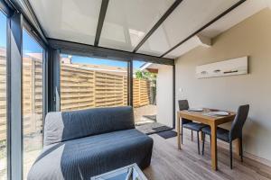 a living room with a couch and a table at Villa Eva in Biscarrosse-Plage