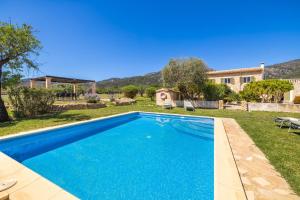 a swimming pool in the yard of a house at Casa de los Almendros in El Port de la Selva