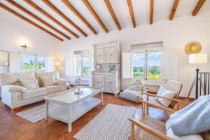 a living room with a couch and a table at Casa de los Almendros in El Port de la Selva