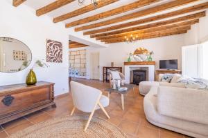 a living room with a couch and a fireplace at Casa de los Almendros in El Port de la Selva