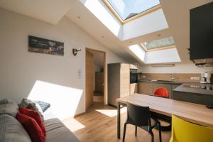 a kitchen and dining room with a large skylight at Balbeinhof Apt Gams in Luson