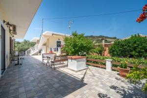 a patio with chairs and tables on a house at Captain Spiros Picola in Gaios